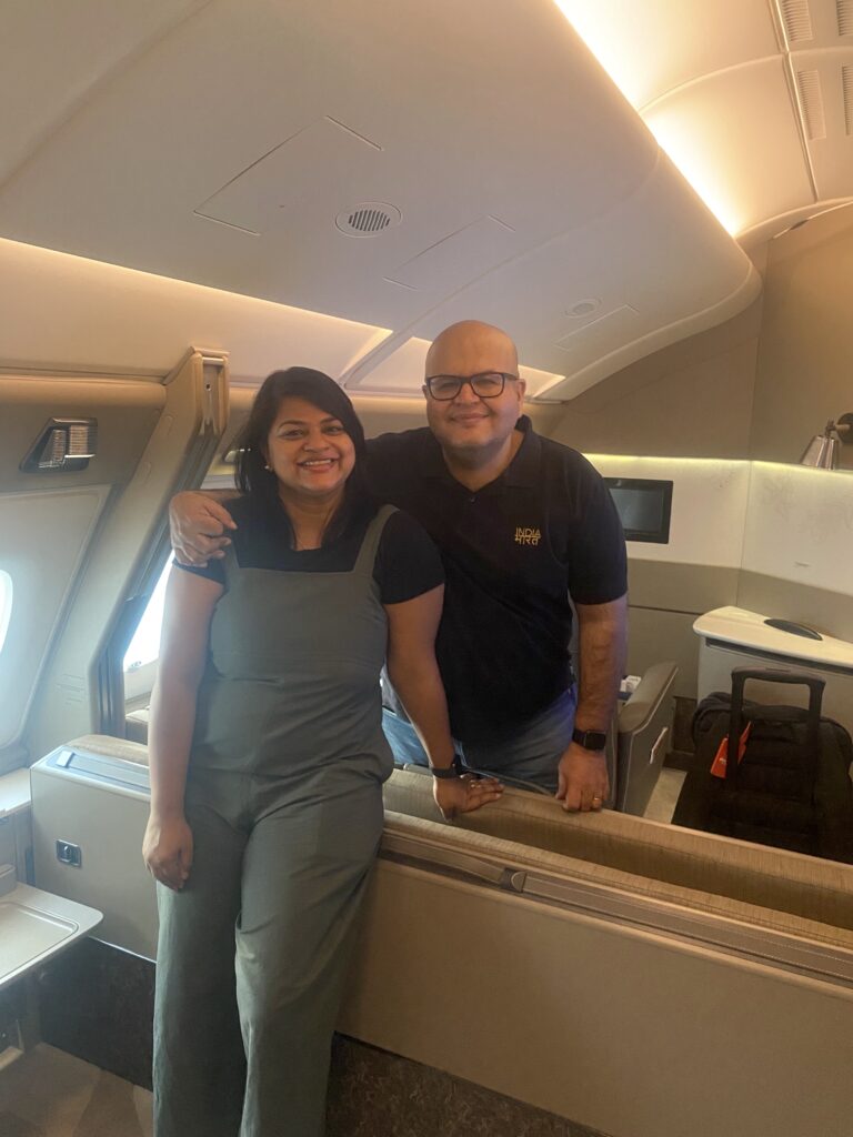 a man and woman standing in an airplane