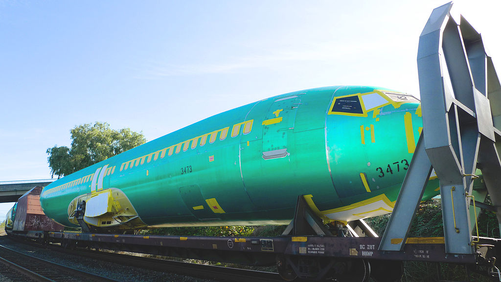 a green airplane on a train