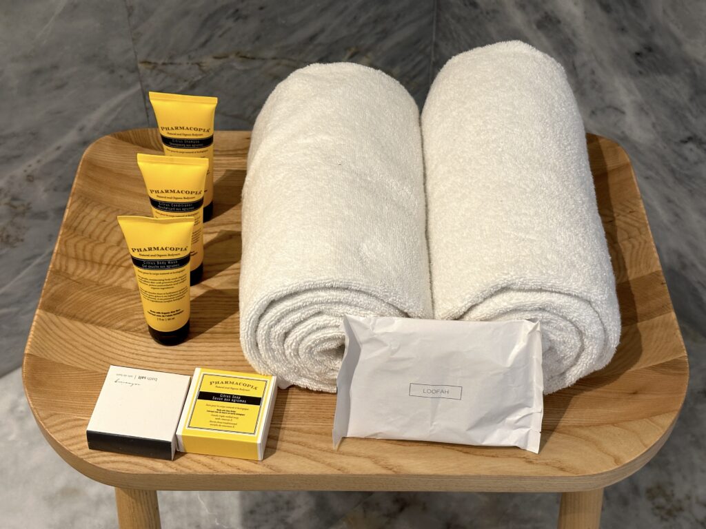 a table with towels and a few packages of toiletries