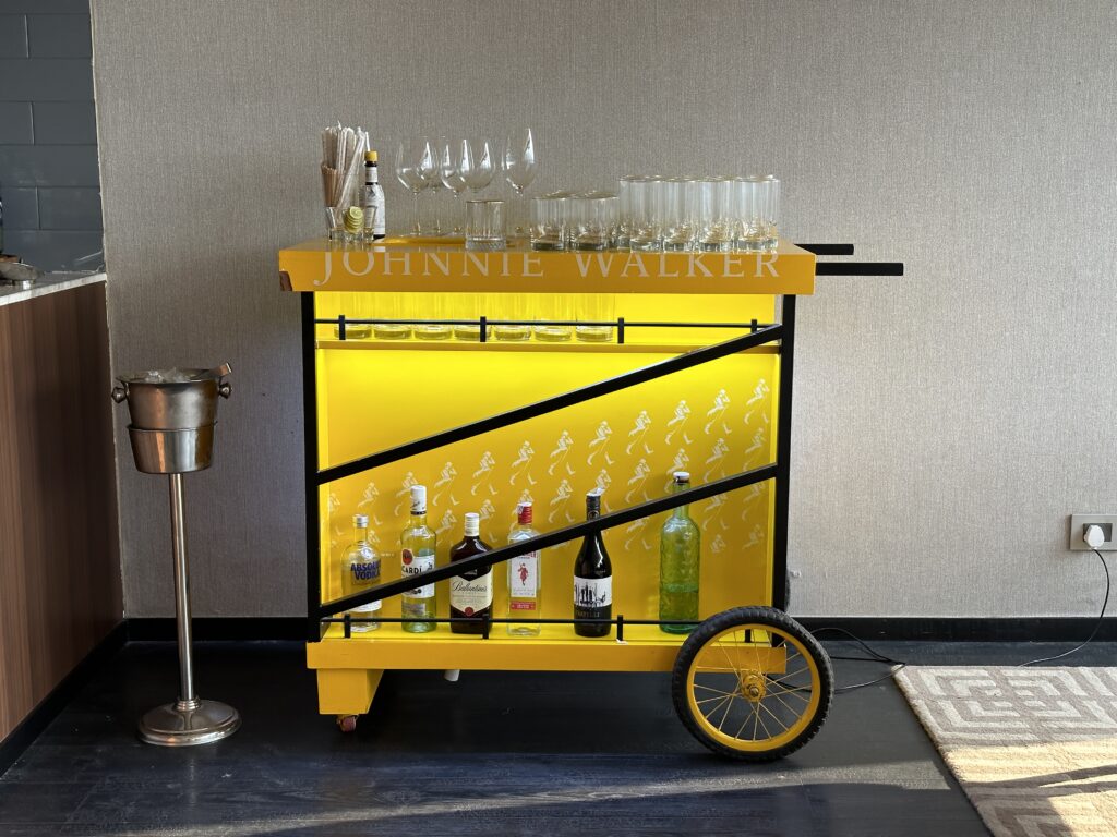 a yellow cart with bottles and glasses on it