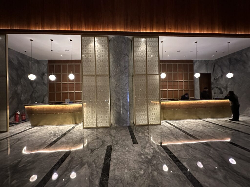 a marble floor with lights and a marble wall