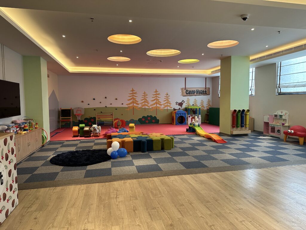 a room with a playroom and a play area