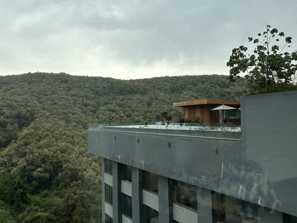 a building with a roof top overlooking a forest