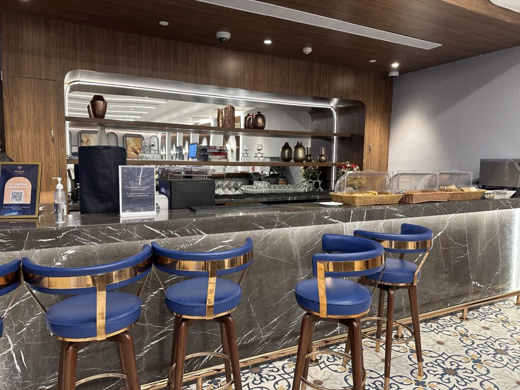 a bar with blue chairs and a tray of bread