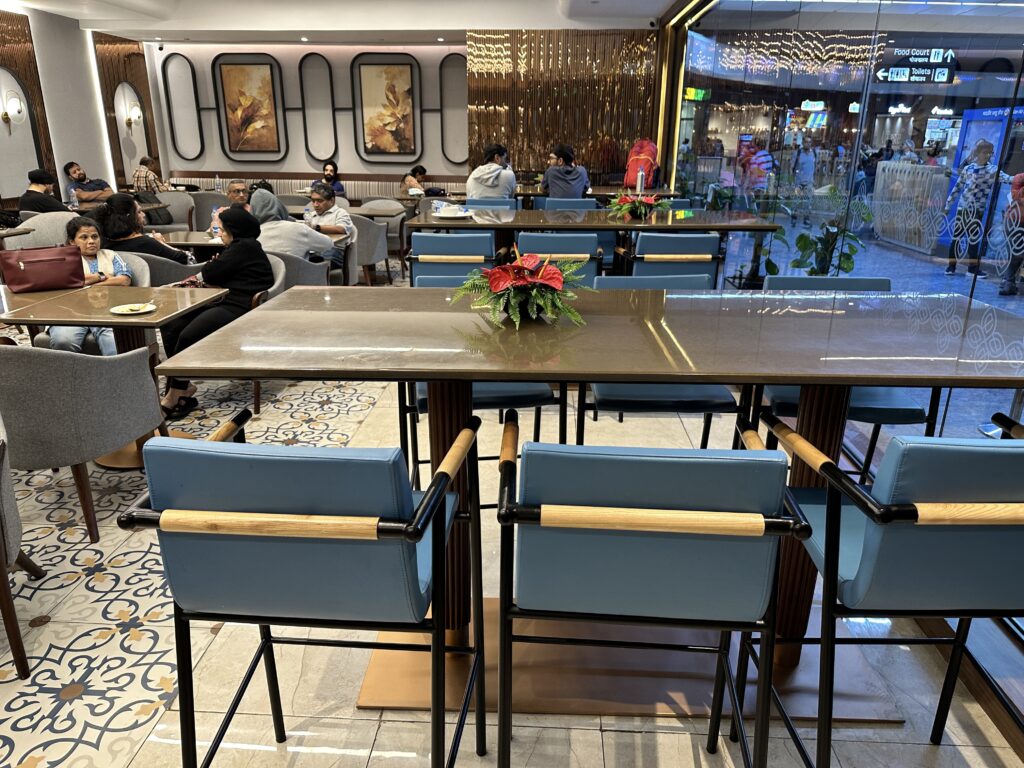 a group of people sitting at tables in a restaurant