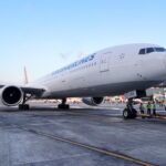 a large white airplane on a runway