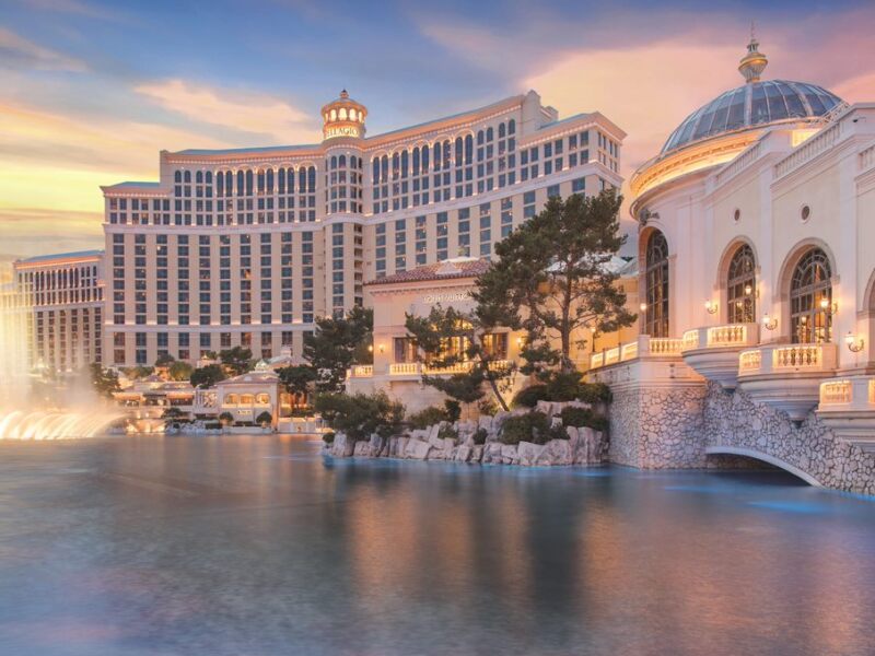 a large building next to a body of water with Bellagio in the background