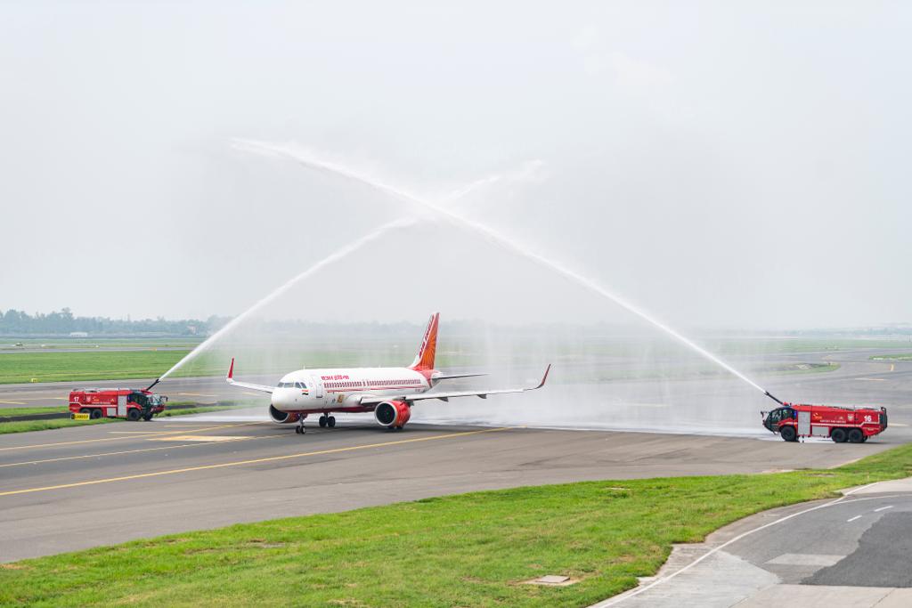 a jet plane spraying water on a runway