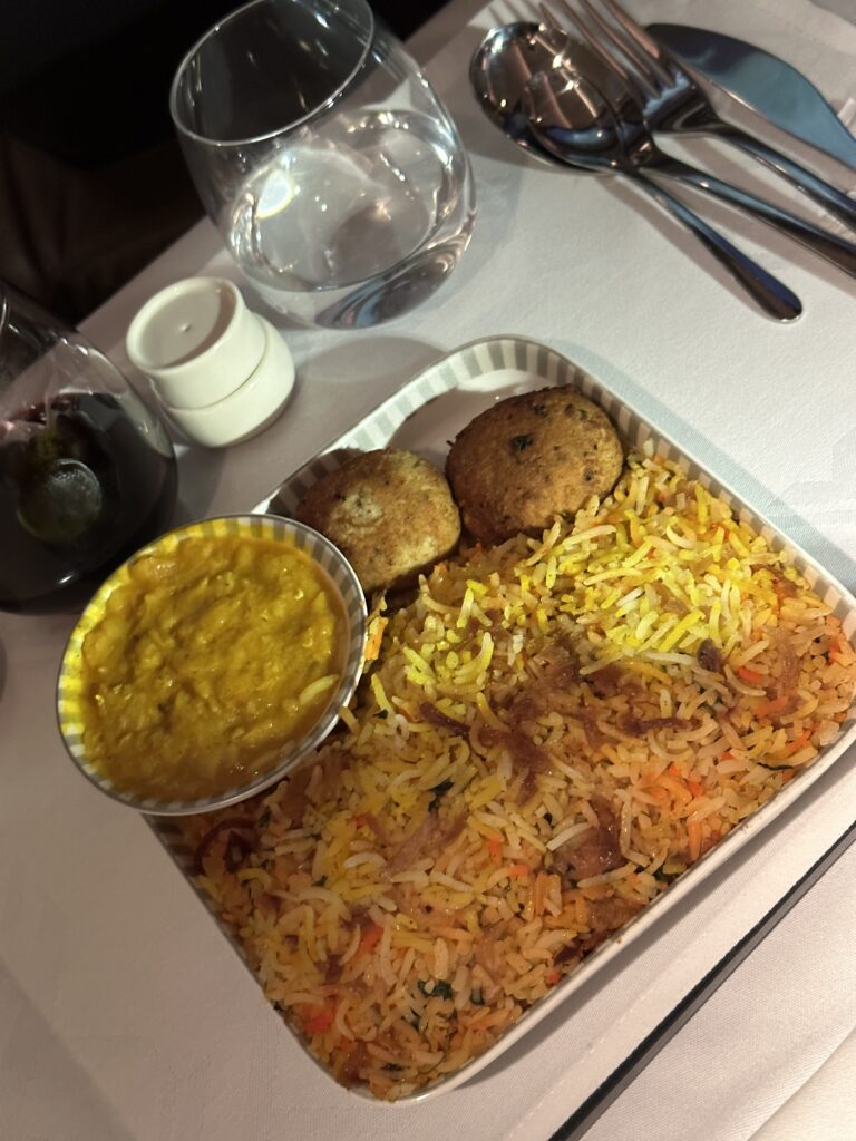 a tray of rice and meatballs with sauce