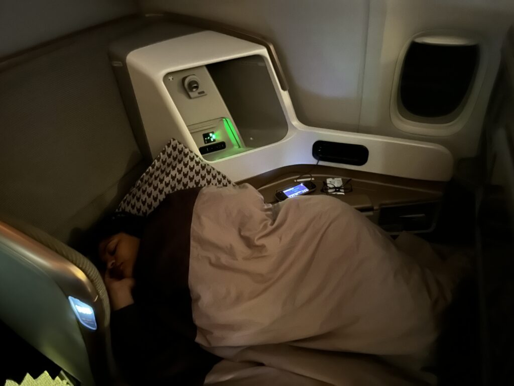 a person sleeping in an airplane