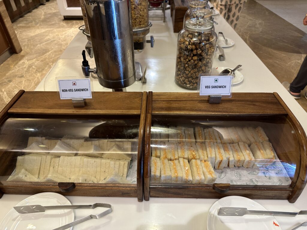 sandwiches in a glass case on a table