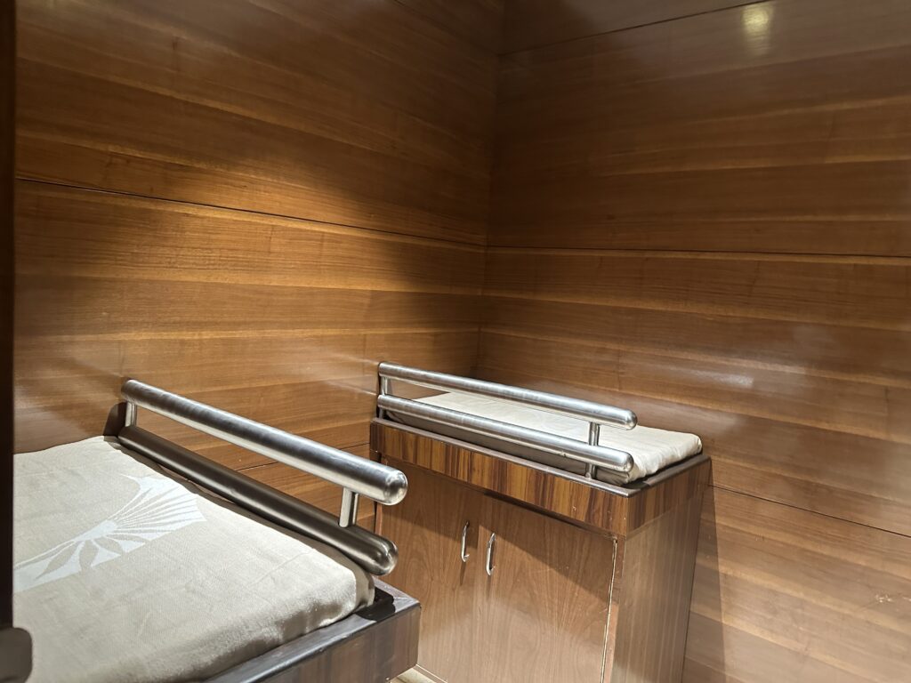 a wooden room with a bed and a cabinet