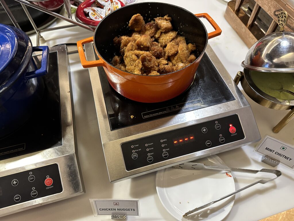 a pan of fried chicken on a stove