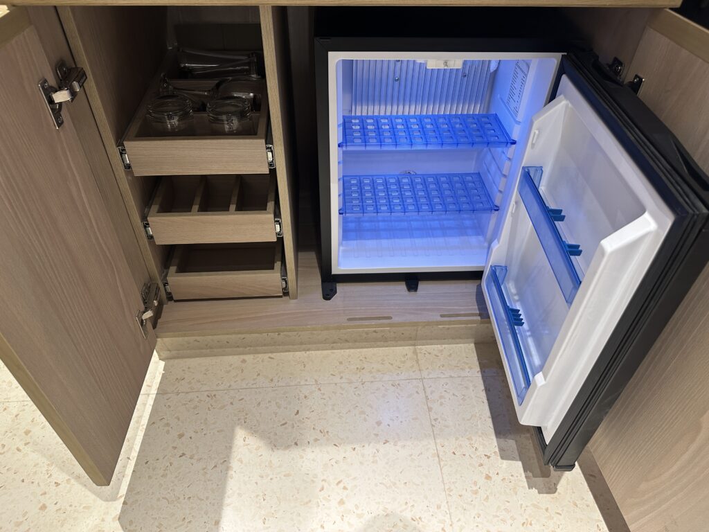 a small refrigerator with a light blue light inside