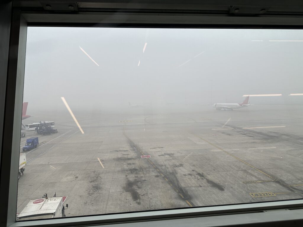 a view of planes on a runway from a window