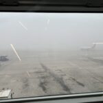 a view of planes on a runway from a window