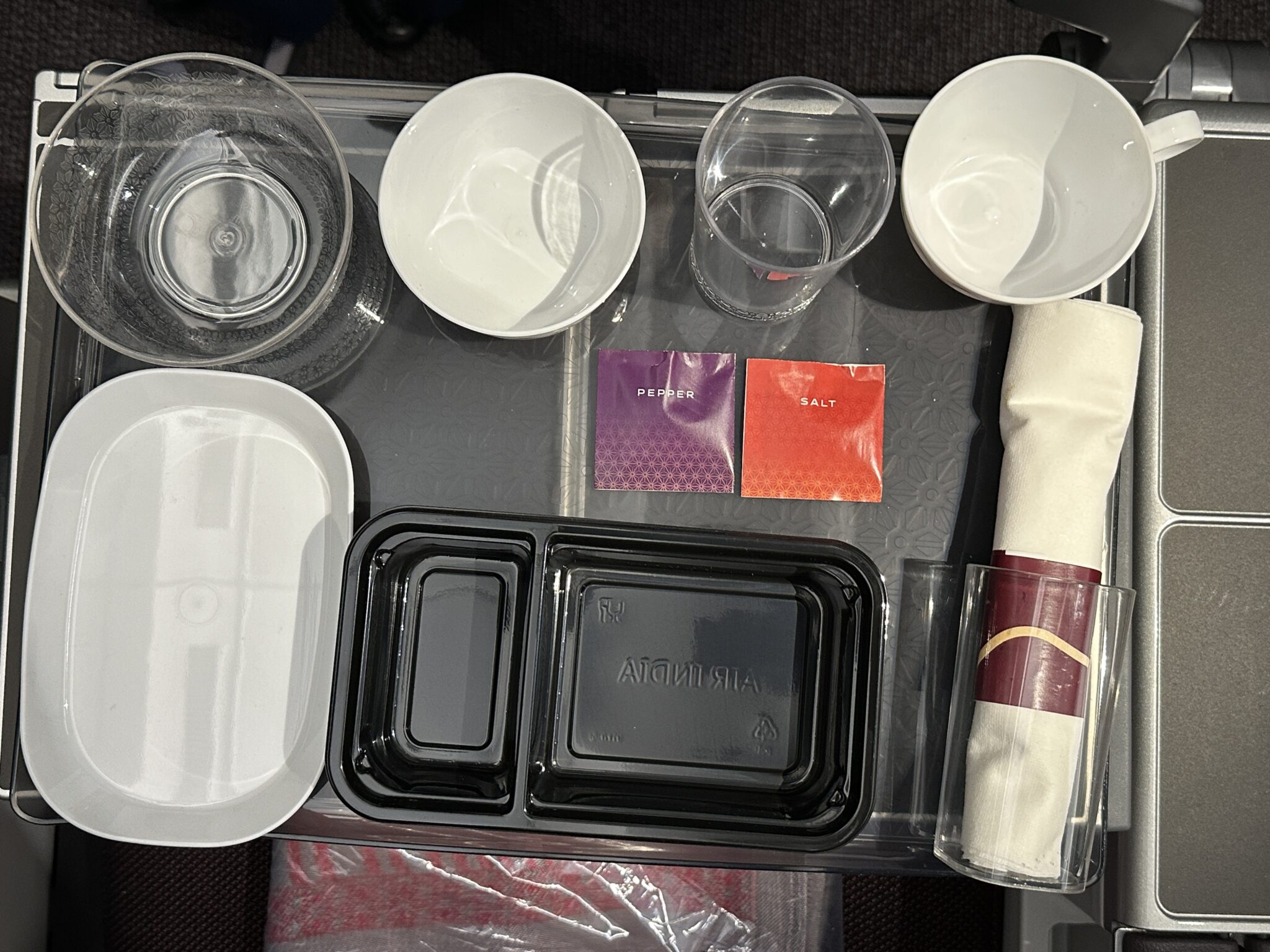 a tray with food containers and a napkin on it