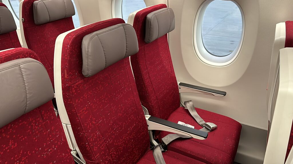 a red and grey seats in an airplane