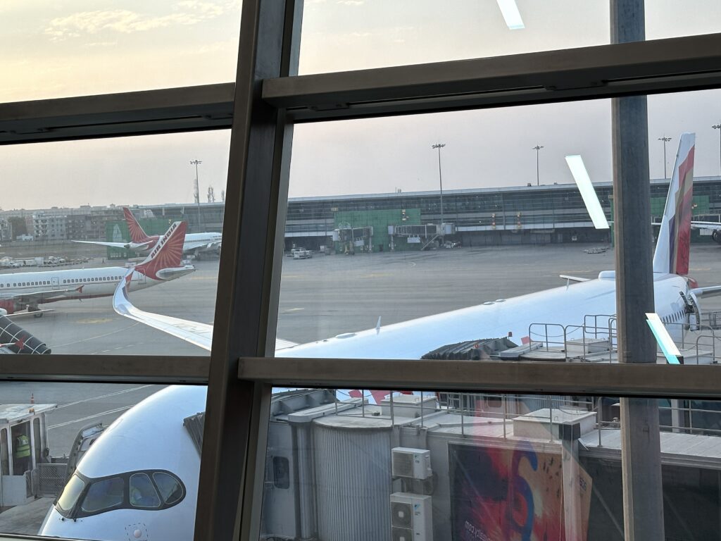 a window with a plane in the background