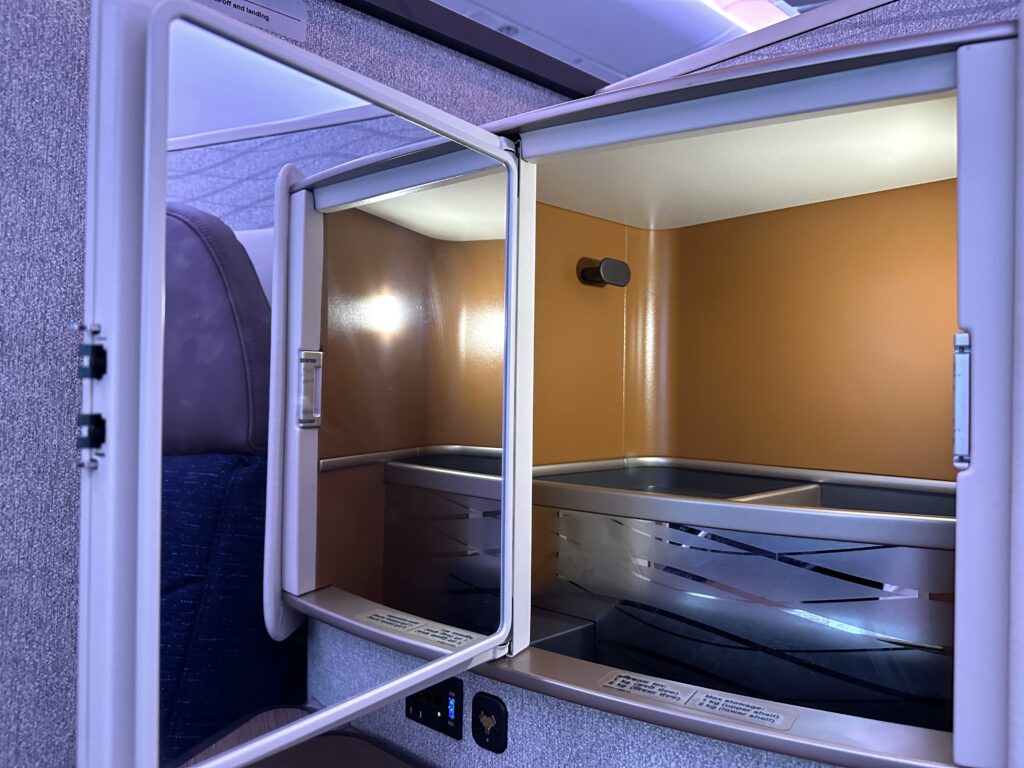 an empty airplane cabin with a small cabinet