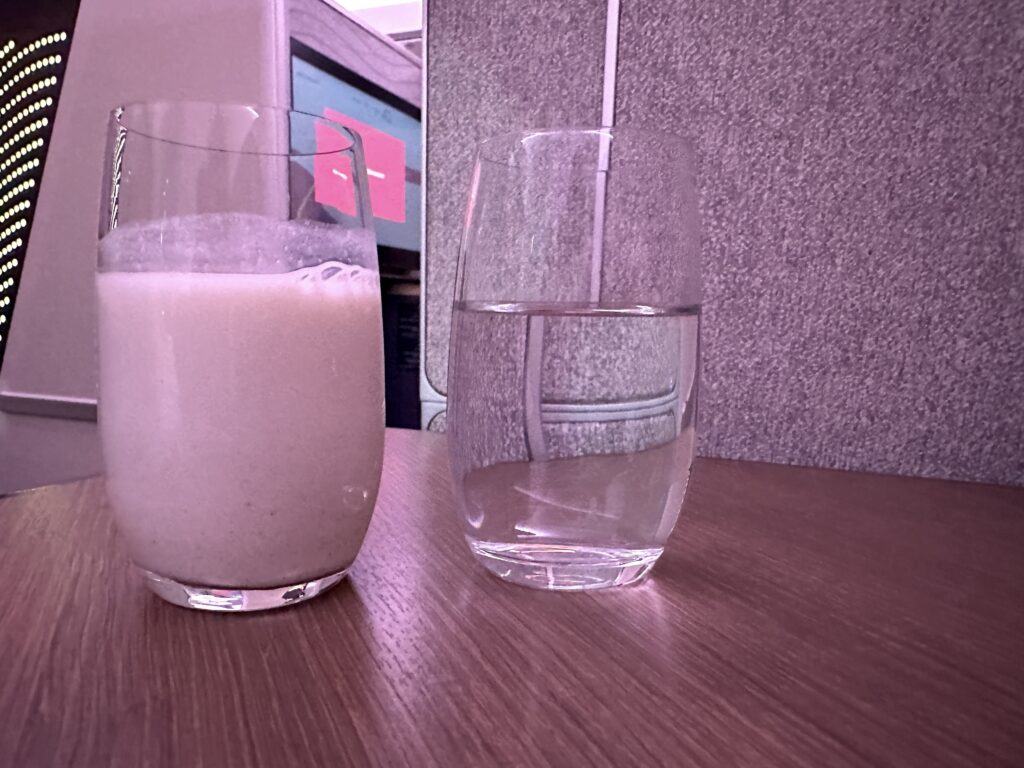 a glass of water and a glass of milk on a table
