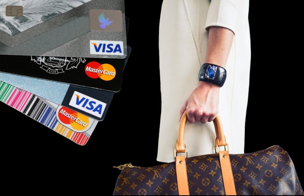 a woman holding a purse and credit cards