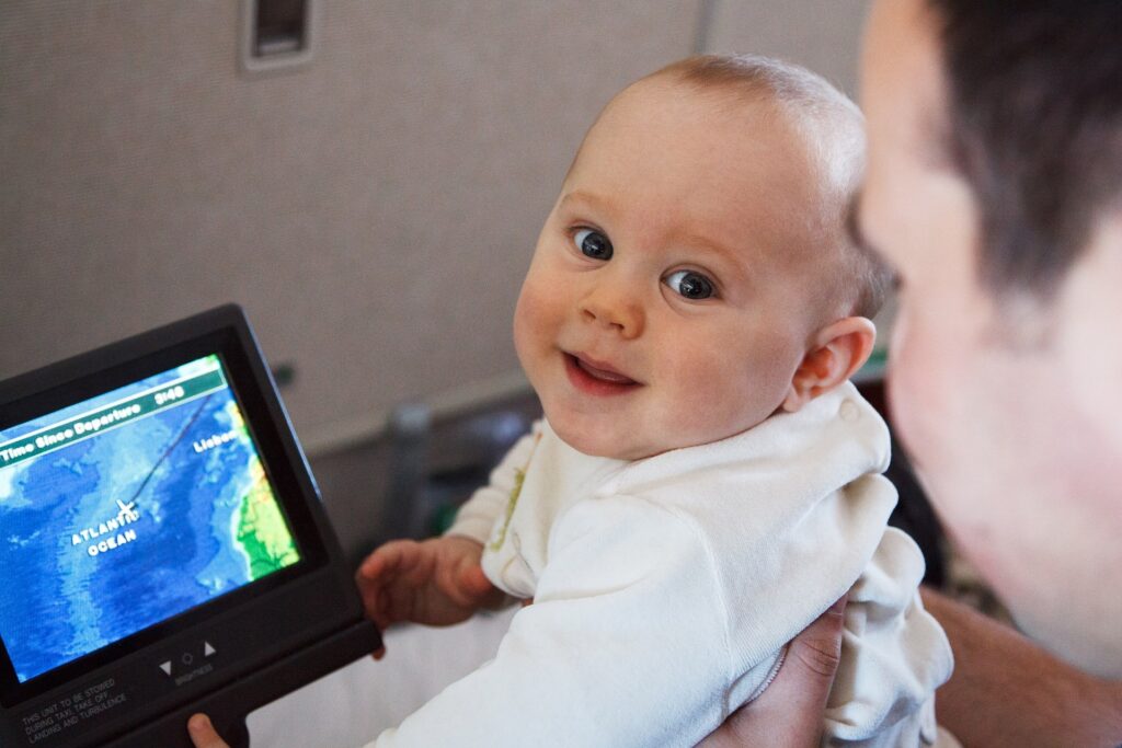 a baby holding a device