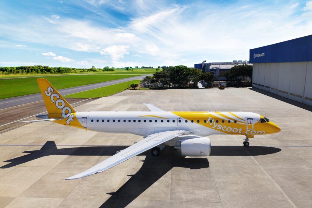 a white and yellow airplane on a runway