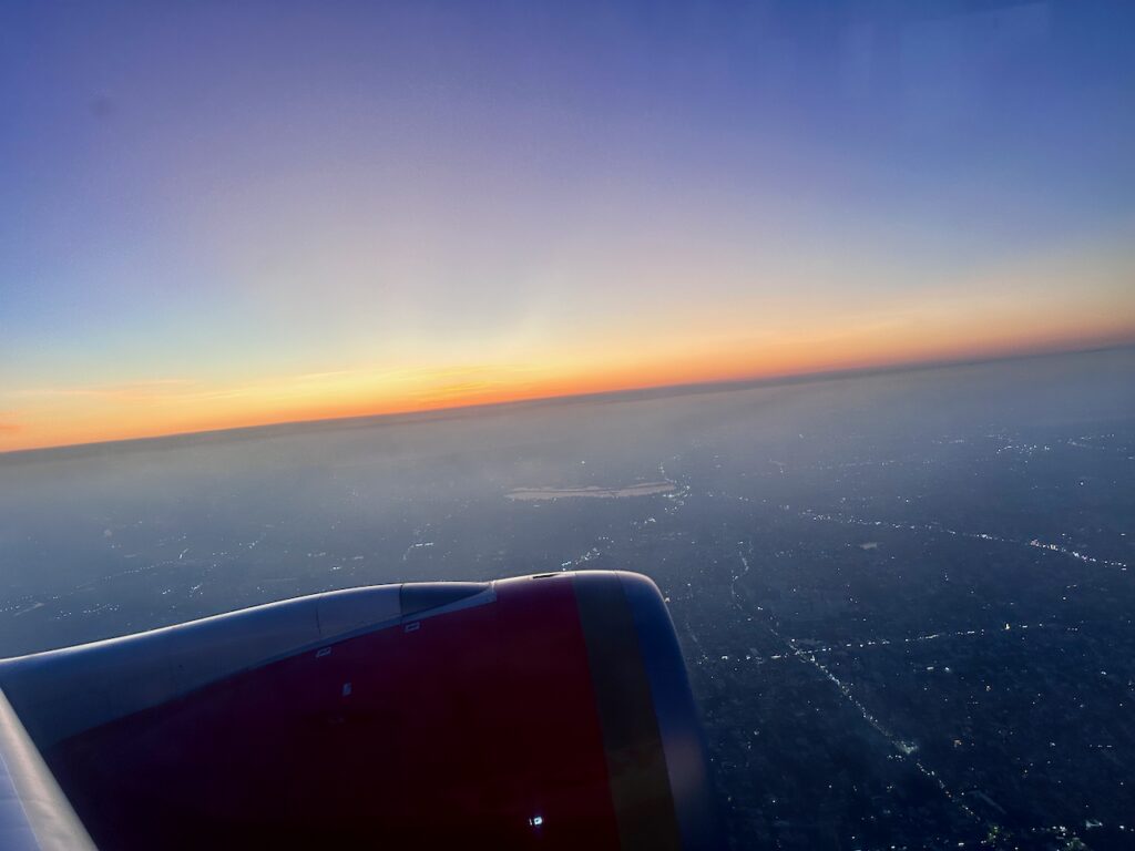 an airplane wing and a city