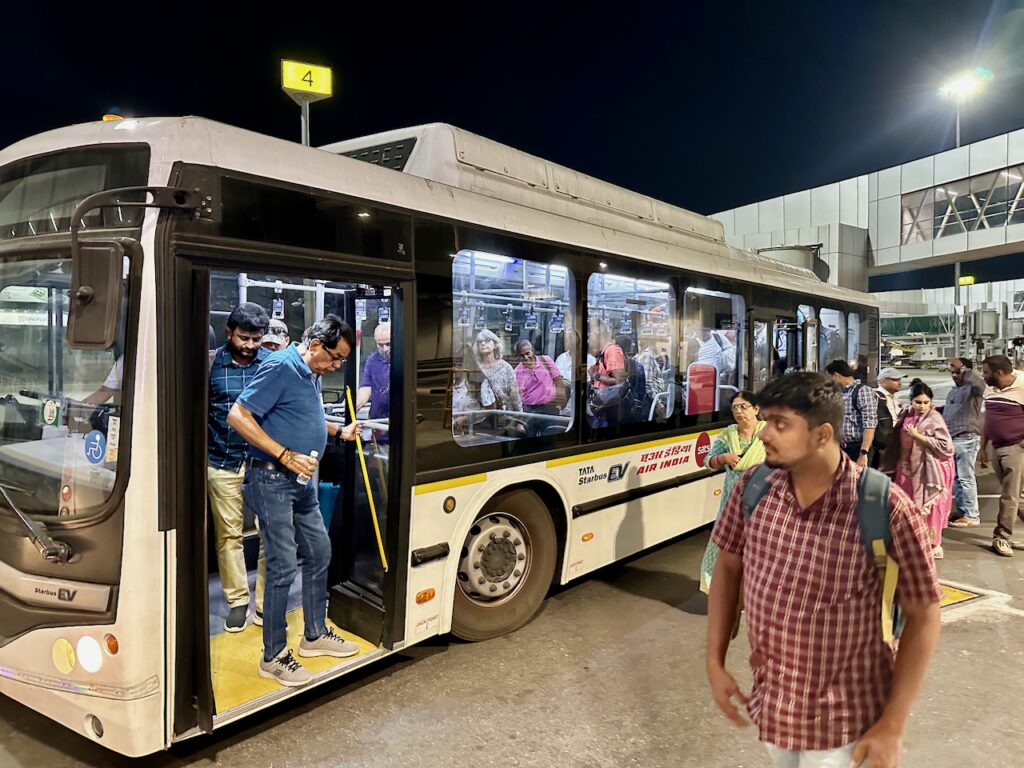 a group of people boarding a bus