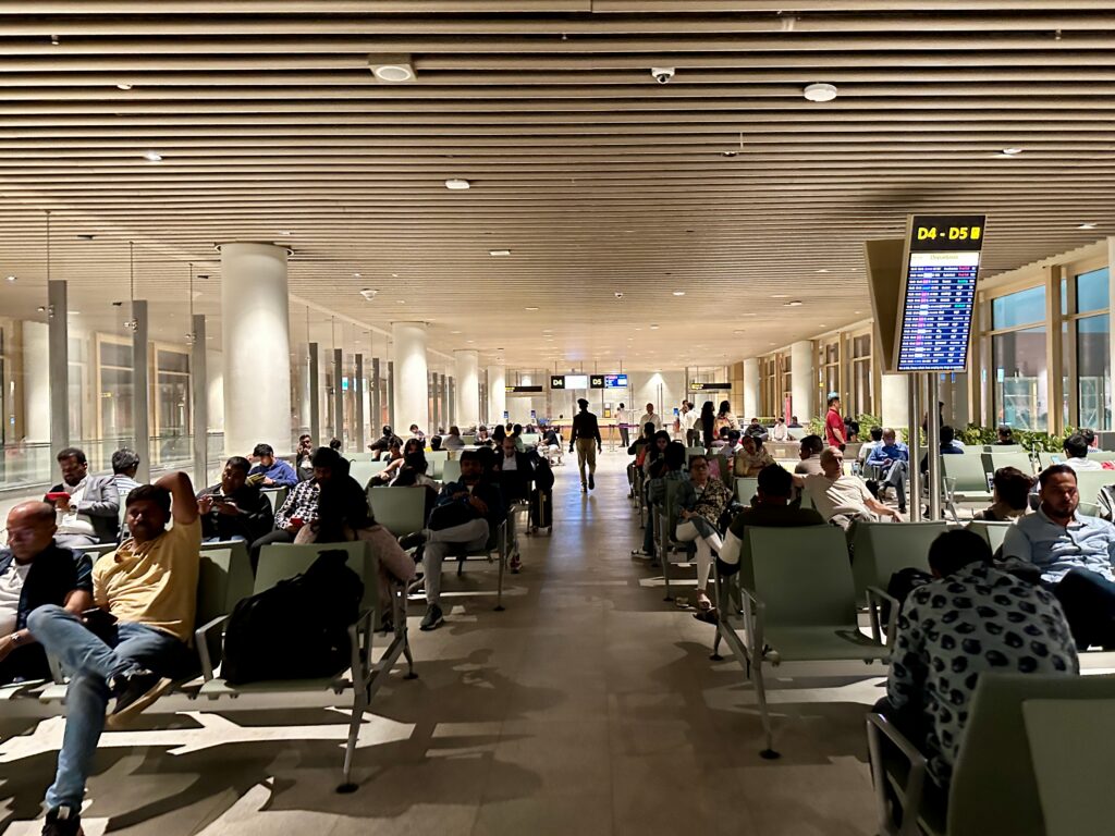 a group of people sitting in chairs in a terminal