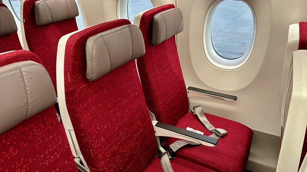 a red and tan seats in an airplane