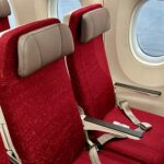 a red and tan seats in an airplane