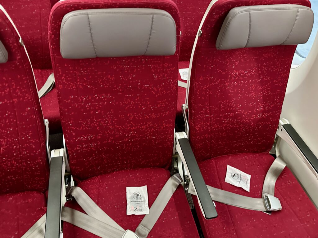 a row of red seats with grey straps