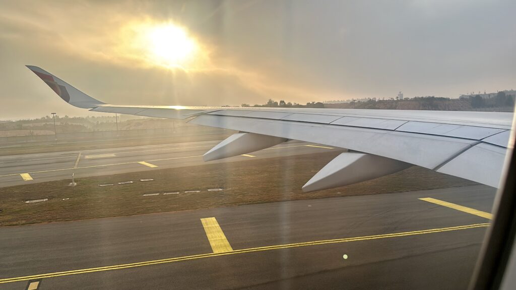 the wing of an airplane on a runway