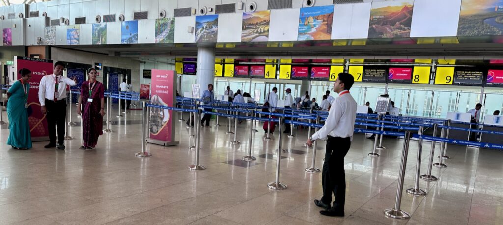 a man standing in a line in a airport