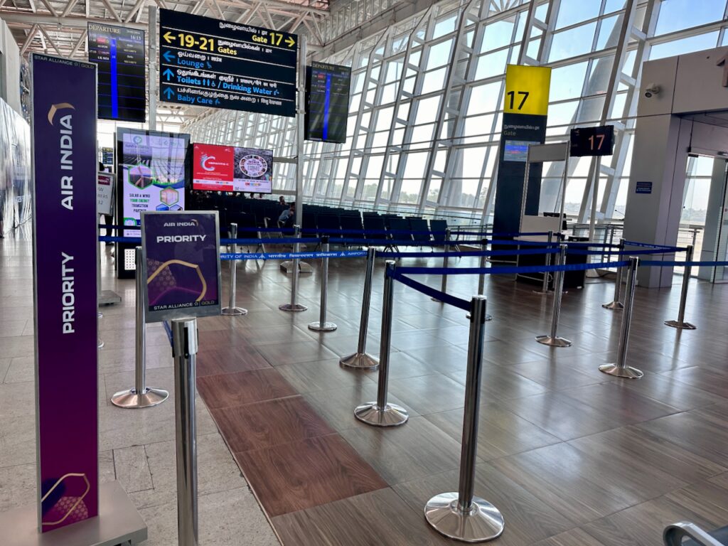 a row of blue chairs in an airport terminal