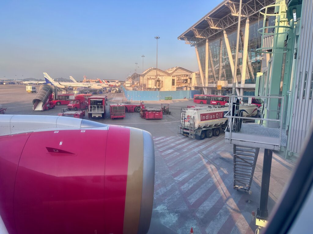 a large airport with airplanes and trucks