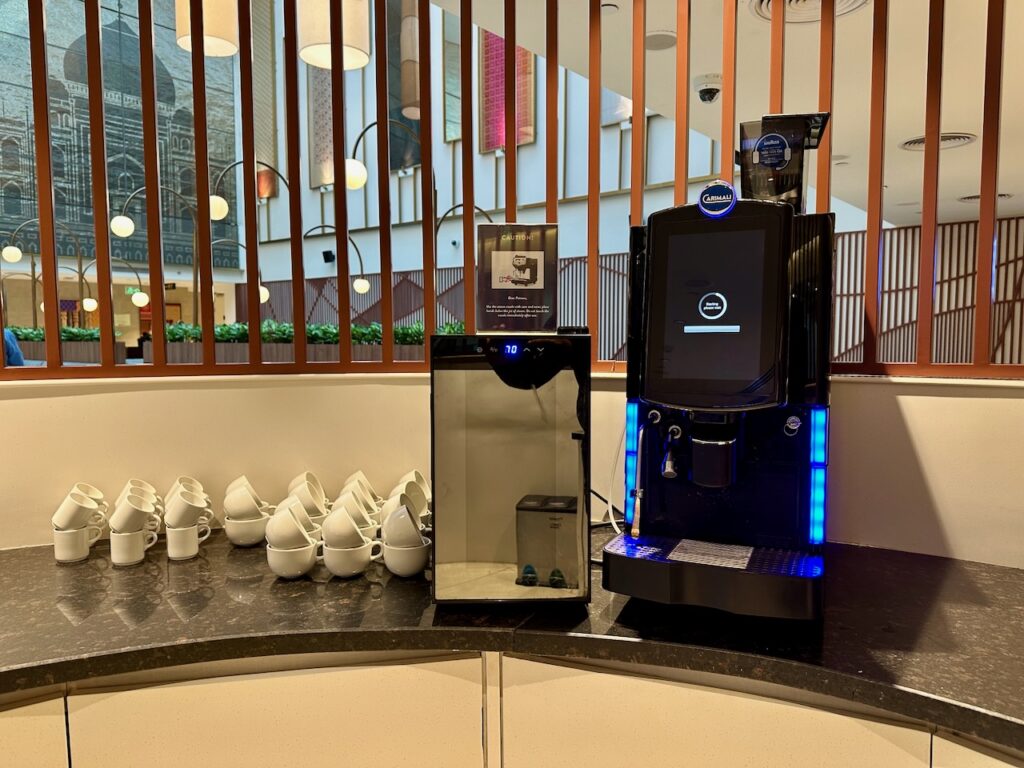 a coffee machine and cups on a counter