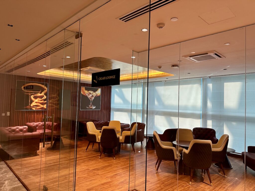 a glass wall with chairs and tables in a room