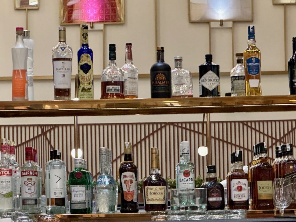 a shelf with bottles of alcohol