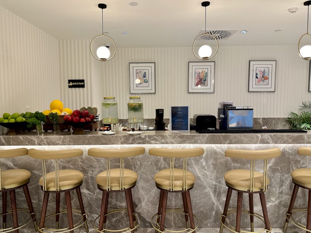 a counter with chairs and fruit in front of it