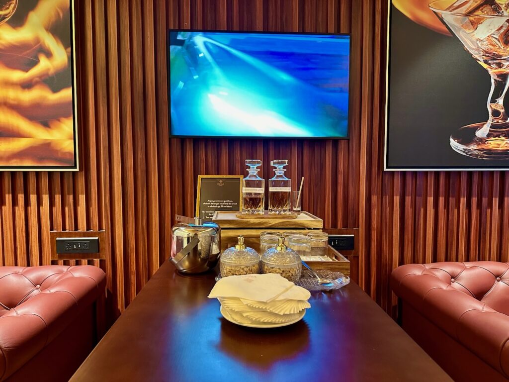 a table with a tray of condiments and a television on the wall