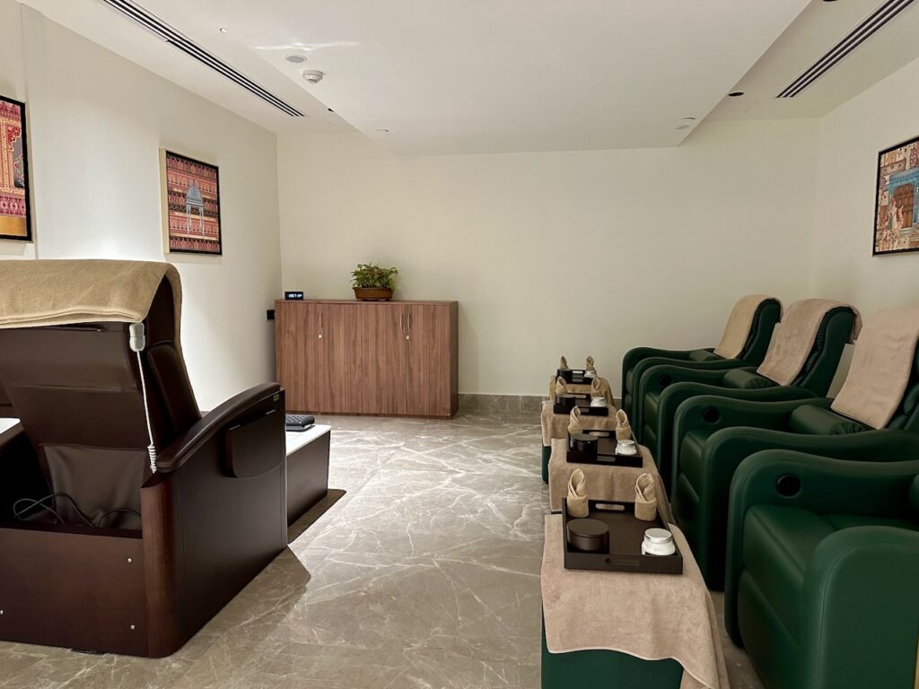 a room with green chairs and a table