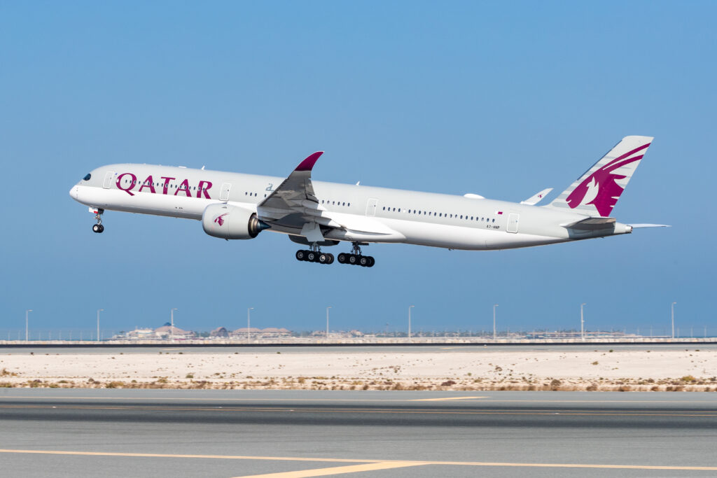 a plane flying over a runway