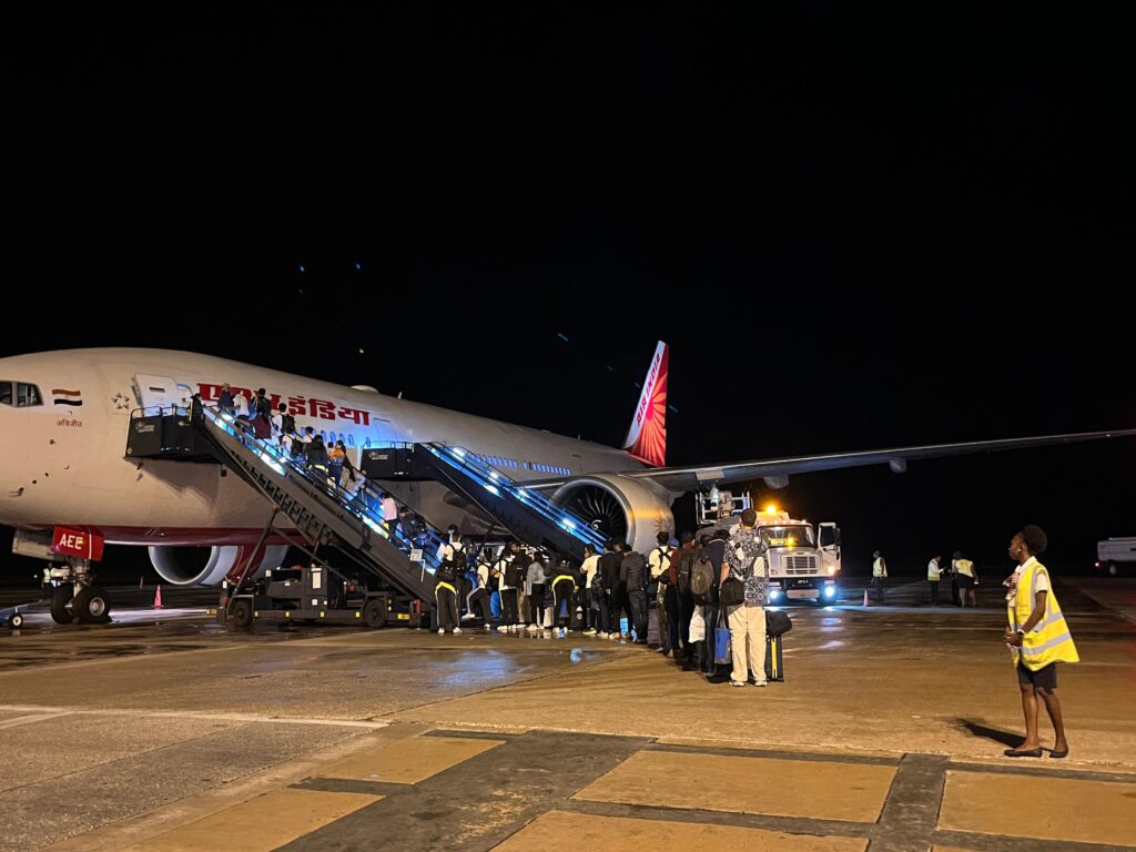 a group of people boarding an airplane