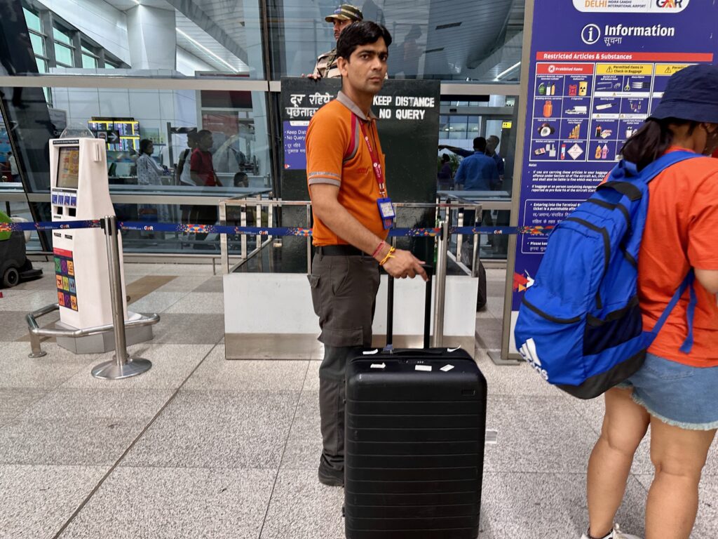 a man standing with a suitcase