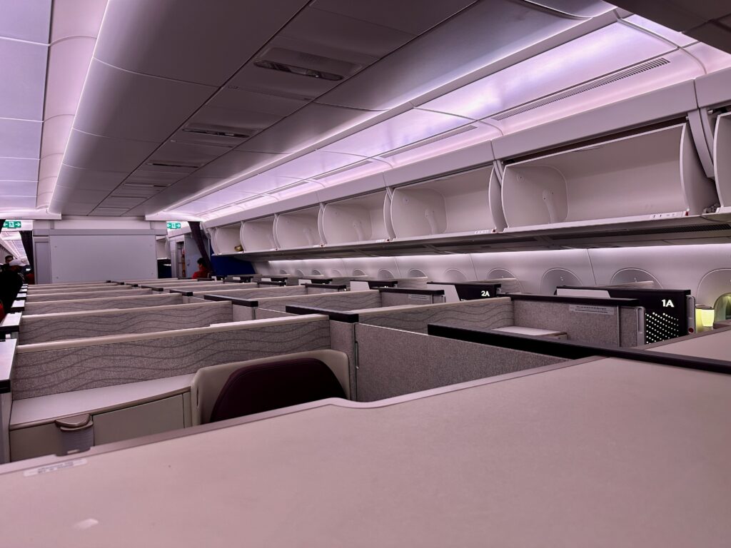 an airplane cabin with cubicles