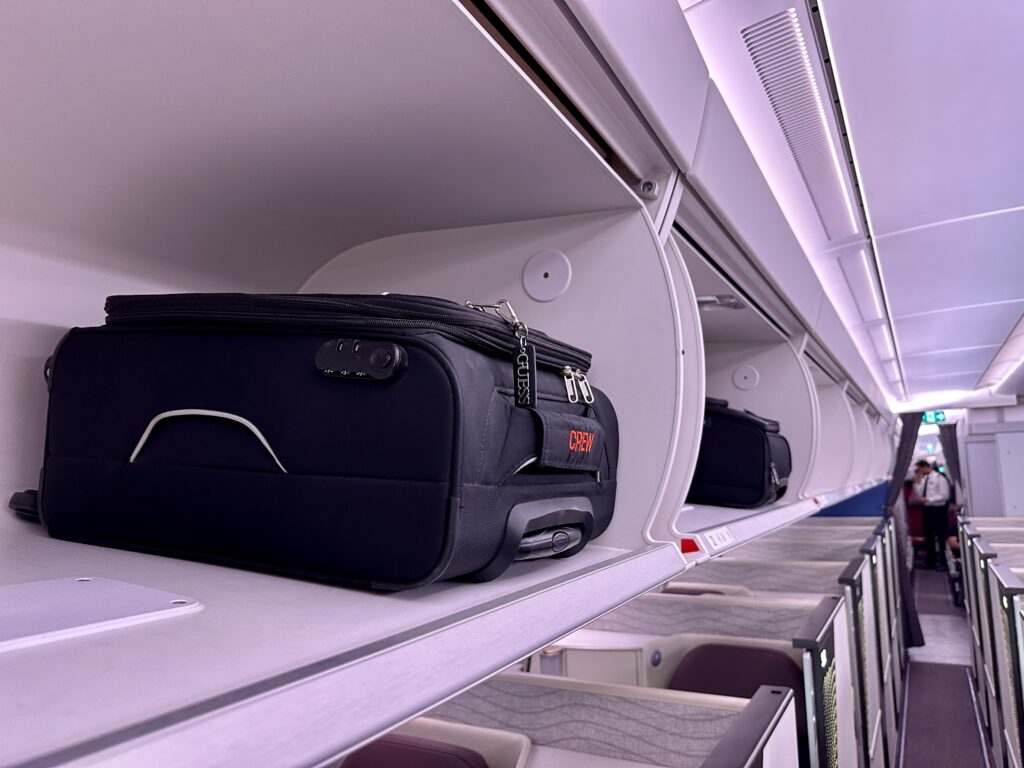 luggage on a shelf in an airplane