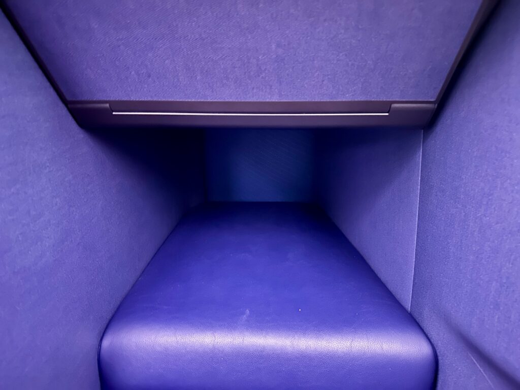 a blue seat in a room